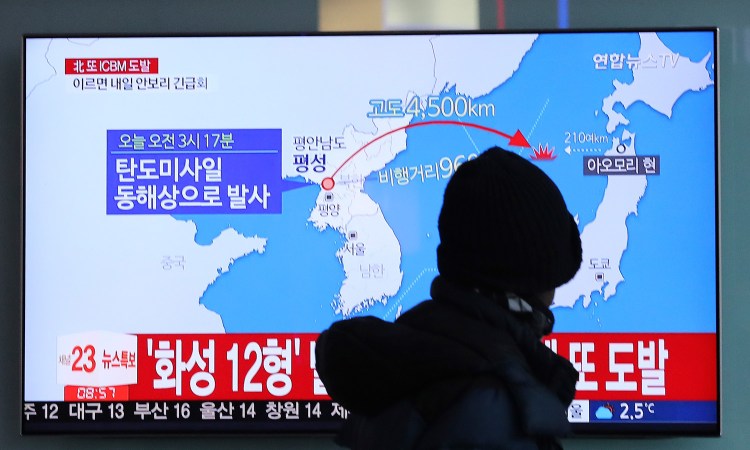 A man watches a TV screen showing a local news program reporting North Korea's missile launch at the Seoul Train Station in Seoul, South Korea, on Wednesday. 