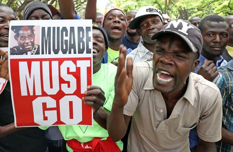 Protesters call for Zimbabwean President Robert Mugabe to resign across the road from parliament in Harare, Zimbabwe, Tuesday.