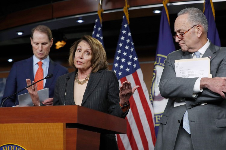  House Minority Leader Nancy Pelosi, D-Calif., and Senate Minority Leader Chuck Schumer, D-N.Y., right, pulled out of a meeting with top Republicans and President Trump on Tuesday after Trump tweeted before the meeting that he couldn't see making a deal to keep the government open. At left is Sen. Ron Wyden, D-Ore., the ranking member of the Senate Finance Committee.