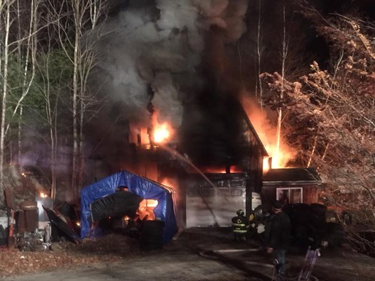 A garage fire in Casco destroyed two cars and blocked traffic on Route 11 for nearly 4 hours.