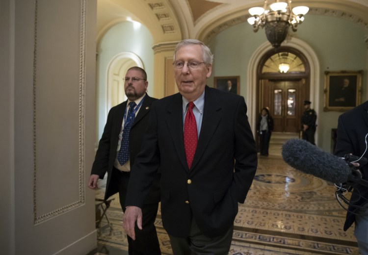 Senate Majority Leader Mitch McConnell, R-Ky., walks from the chamber to his office as the Republican tax bill nears a vote on Capitol Hill in Washington late Friday night. The Senate passed the measure, 51-49 on party lines, early Saturday morning.