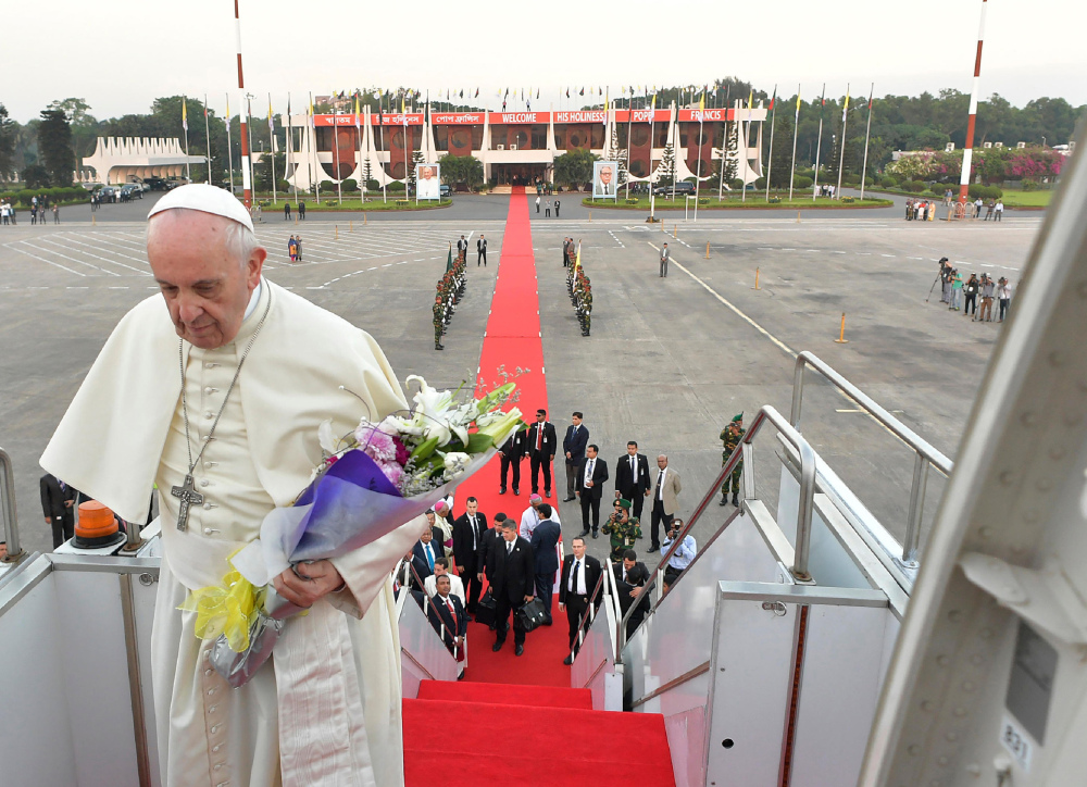 Pope Francis boards an airplane as he prepares to depart from the airport in Dhaka, Bangladesh, Saturday. Francis urged Bangladeshi priests and nuns to resist the "terrorism of gossip" that can tear religious communities apart, delivering one of his spontaneous speeches to the country's Catholic leadership at the close of his Asian tour.