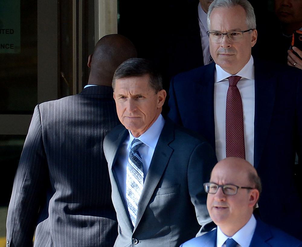 Washington Post/Essdras M Suarez
Former National Security Adviser Michael Flynn leaves the E. Barrett Prettyman U.S. Courthouse on Friday surrounded by members of his legal team.