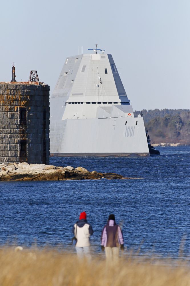People watch as the newest Zumwalt-class stealth destroyer built by BIW passes Fort Popham as it takes a test run Monday down the Kennebec River.