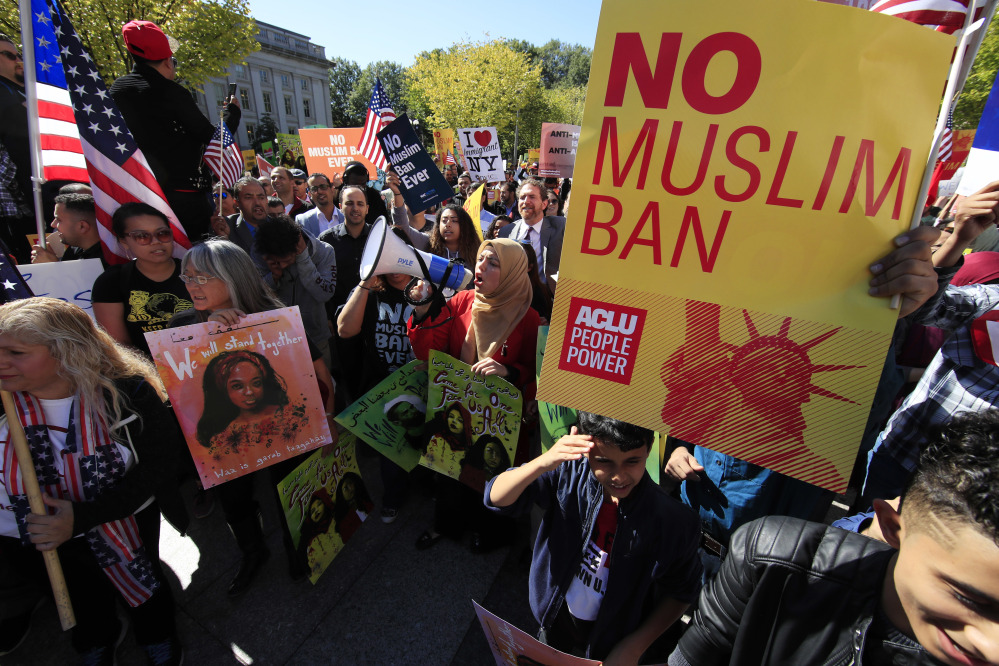 Protesters gather at a rally in Washington in October. The Supreme Court Monday voted to allow the Trump administration to fully enforce a ban on travel to the United States by residents of six mostly Muslim countries.