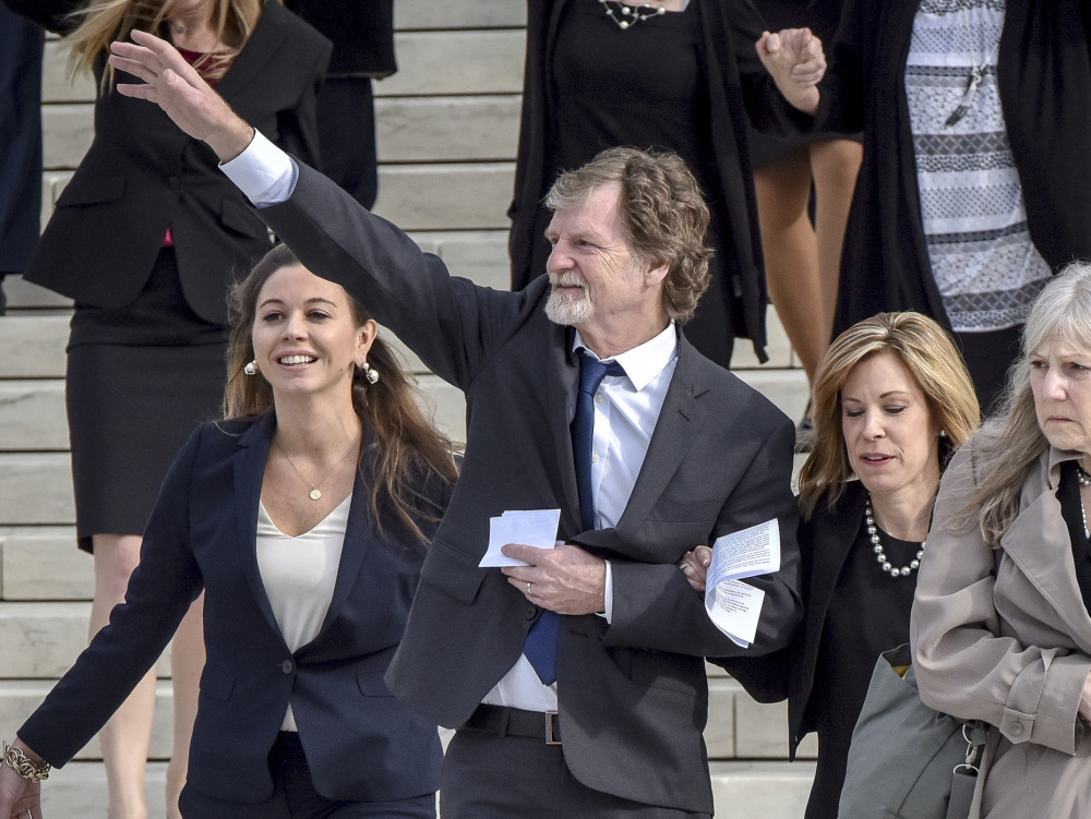 Jack Phillips, the baker who refused to make a cake for a gay couple, waves outside the Supreme Court on Tuesday.