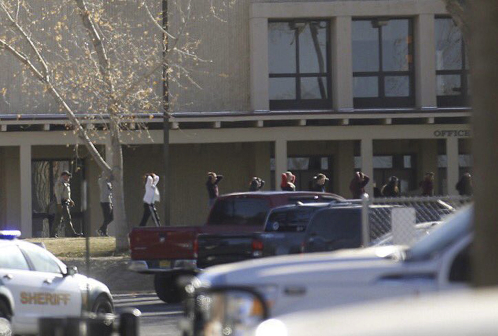 Students are led out of Aztec High School after a shooting Thursday in Aztec, New Mexico. The school is in the Four Corners region and is near the Navajo Nation.
