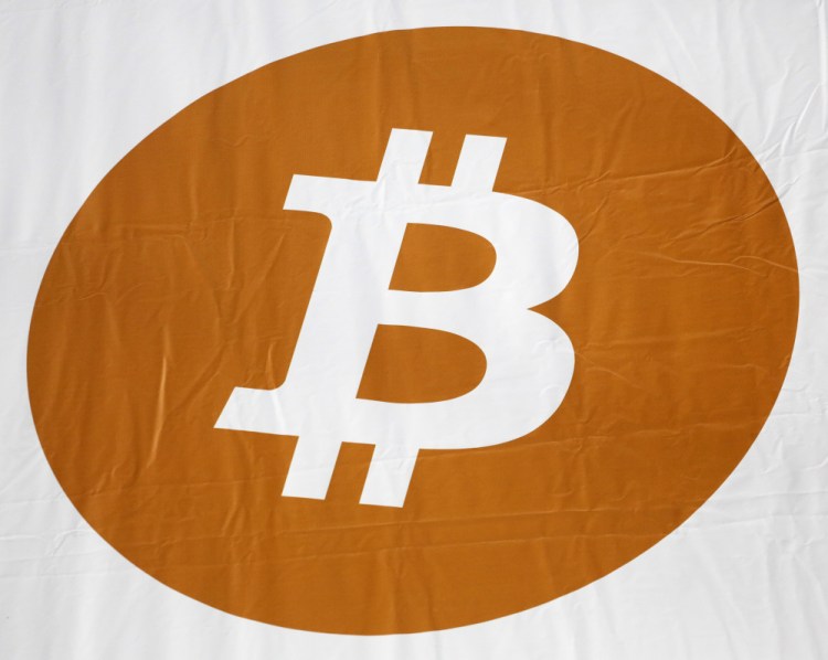 A bitcoin logo is displayed at the Inside Bitcoins conference and trade show in New York.