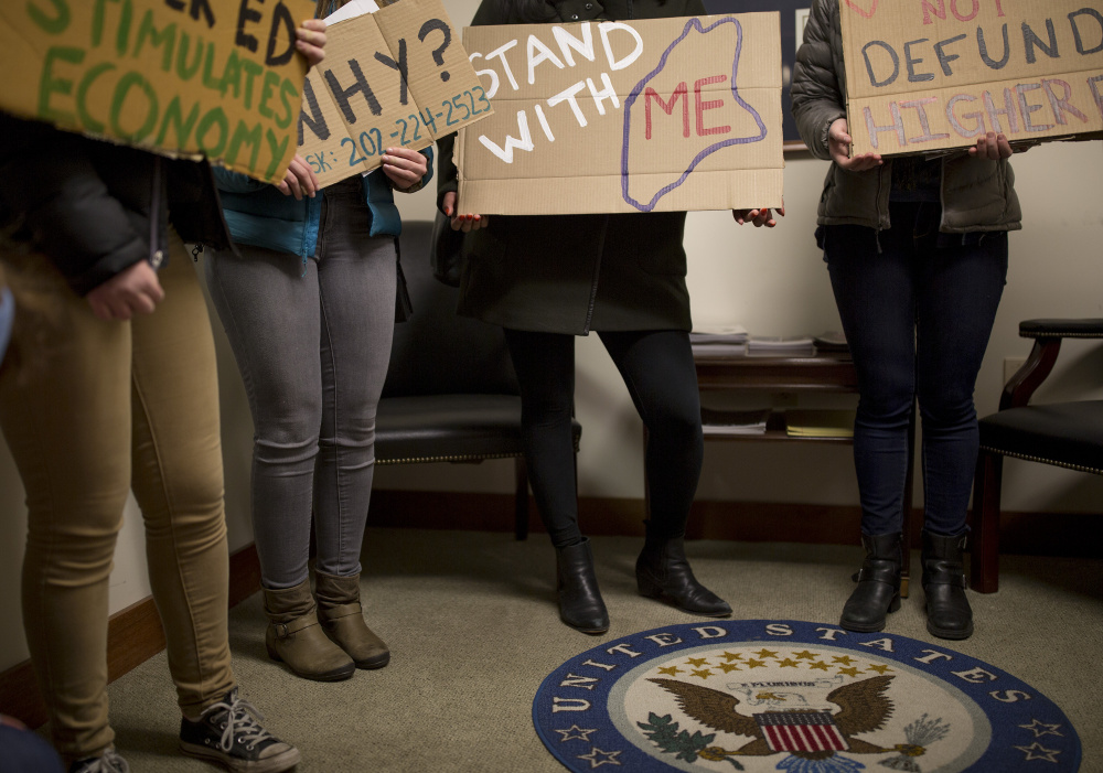 Bowdoin students protest inside Sen. Susan Collins' Portland office Friday, calling for her to vote no on the Republican tax bill.