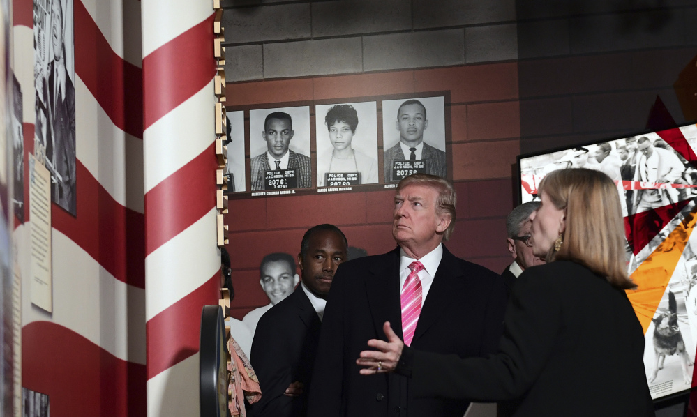 President Trump listens to Museum Division Director Lucy Allen during a tour of the newly opened Mississippi Civil Rights Museum in Jackson, Miss.,  on Saturday.