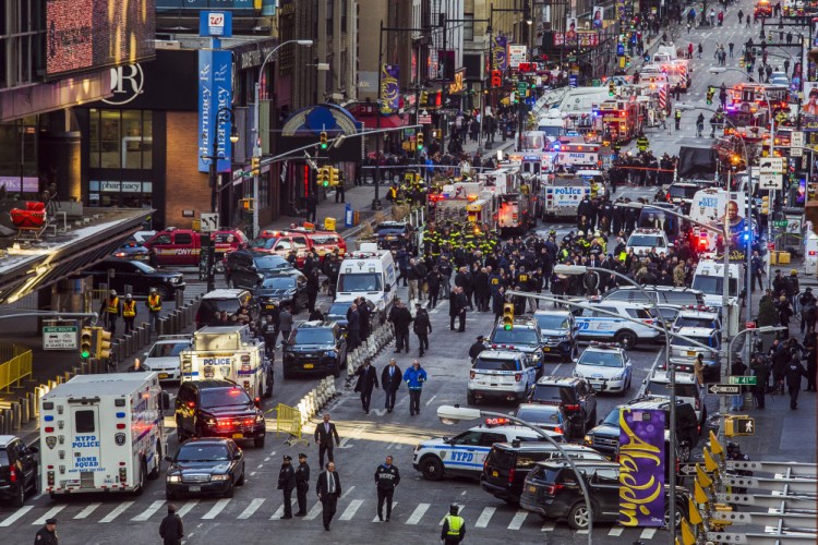 Law enforcement officials work following an explosion near New York's Times Square on Monday.