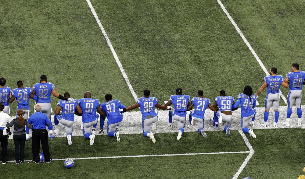 Detroit Lions players take a knee during the national anthem before an NFL game against the Atlanta Falcons in Detroit on Sept. 24, 2017.