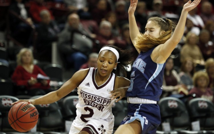 Morgan William, who sank the buzzer-beating basket in last season's NCAA semifinal that ended Connecticut's 111-game winning streak, drives against Maine's Dor Saar during Mississippi State's 83-43 victory Sunday.