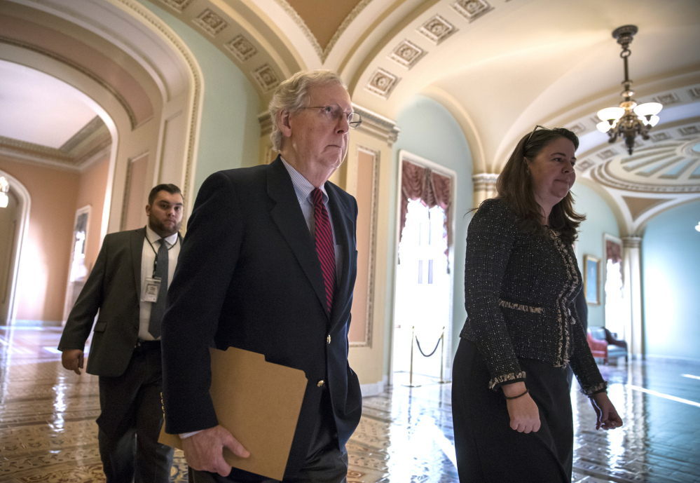 Senate Majority Leader Mitch McConnell, R-Ky., walks to the Senate chamber Monday as Republicans in Congress prepare to pass their $1.5 trillion tax bill on party-line votes this week. The House is likely to vote Tuesday and the Senate either Tuesday or Wednesday.