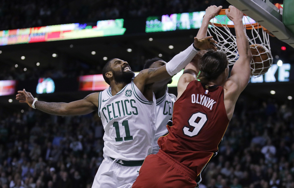 Miami Heat center Kelly Olynyk, a Celtic until this year, beats Celtics guard Kyrie Irving to the basket for a dunk in the second half of Miami's one-point win in Boston on Wednesday night. Olynyk scored a career-high 32 points in the game.