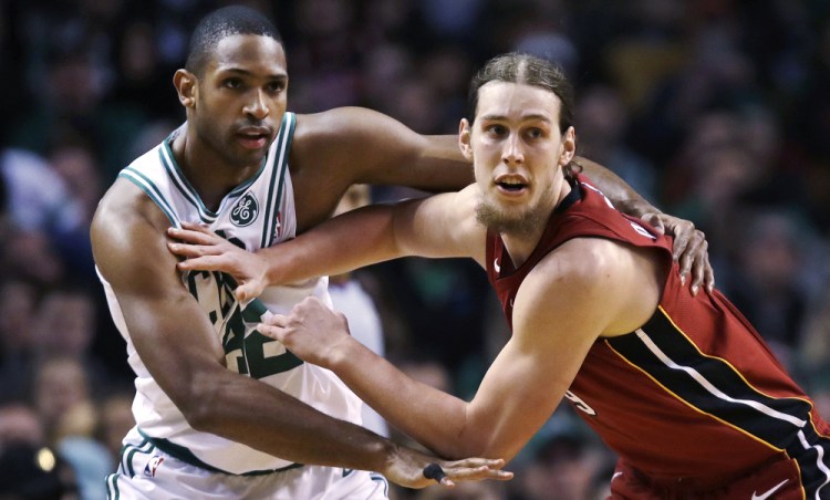 Kelly Olynyk pushes off Celtics forward Al Horford while trying to receive a pass in the first quarter.