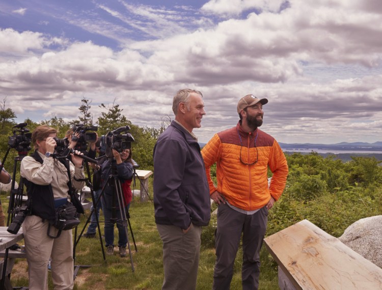 Interior Secretary Ryan Zinke, left, and Lucas St. Clair look out over the Katahdin Woods & Waters National Monument in June. The new park survived a federal review of monuments nationwide considered for possible downsizing or expanded logging.
