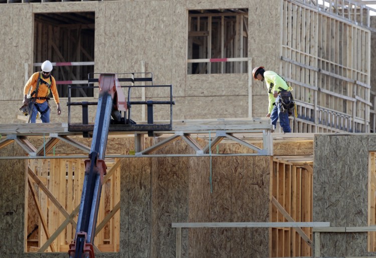Construction workers build a residential complex in Nashville, Tenn. The U.S. economy grew at a 3.2 percent annual rate from July through September.