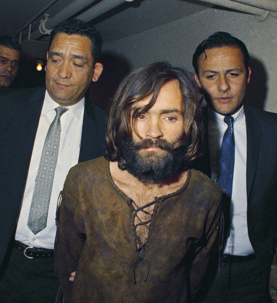 Charles Manson is escorted to his arraignment in 1969on conspiracy-murder charges .