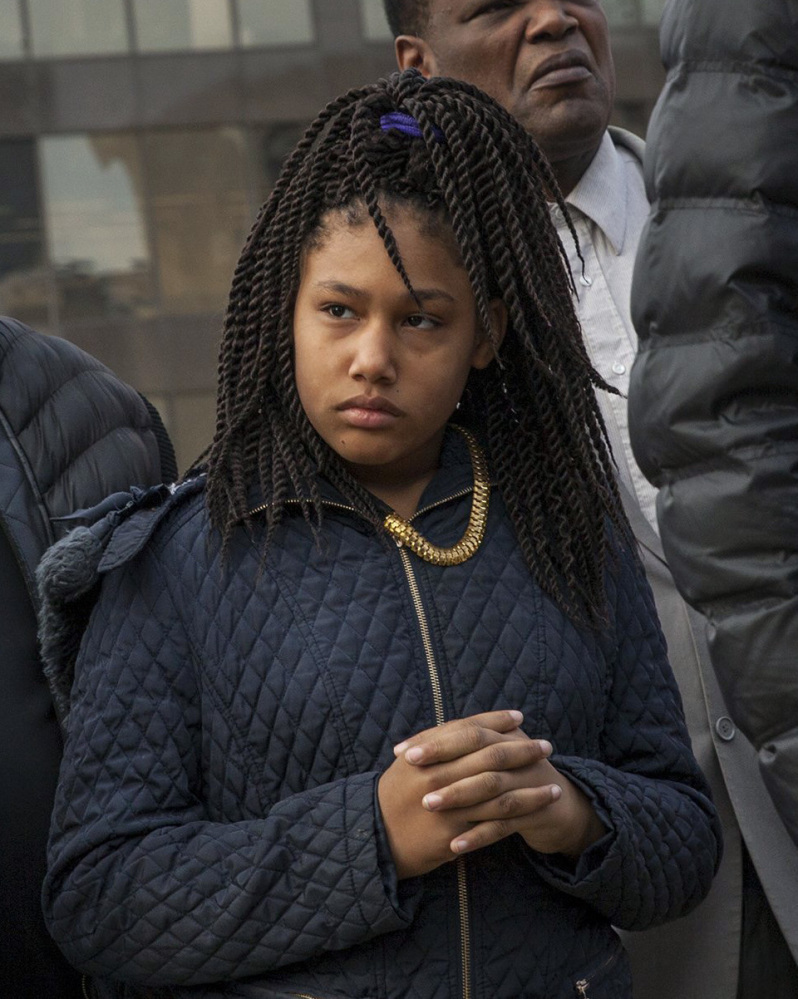 Honestie Hodges, 11, listens during a Greater Grand Rapids NAACP news conference.
