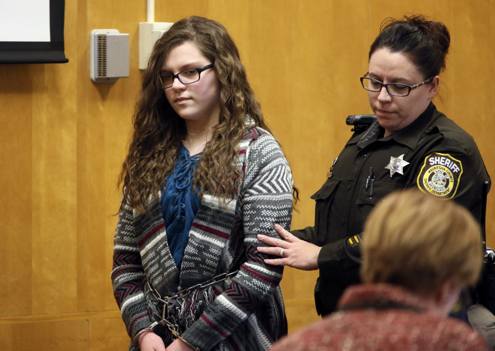 Anissa Weier, one of two Wisconsin girls who tried to kill a classmate to win favor with a fictional character, is led into the Waukesha County Court for her sentencing Thursday.