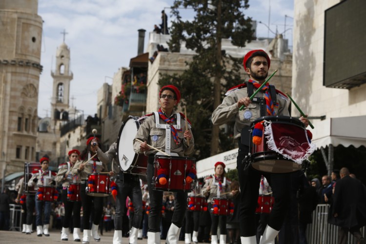 Members of a Palestinian marching band parade during Christmas celebrations outside the Church of the Nativity in Bethlehem on Sunday.