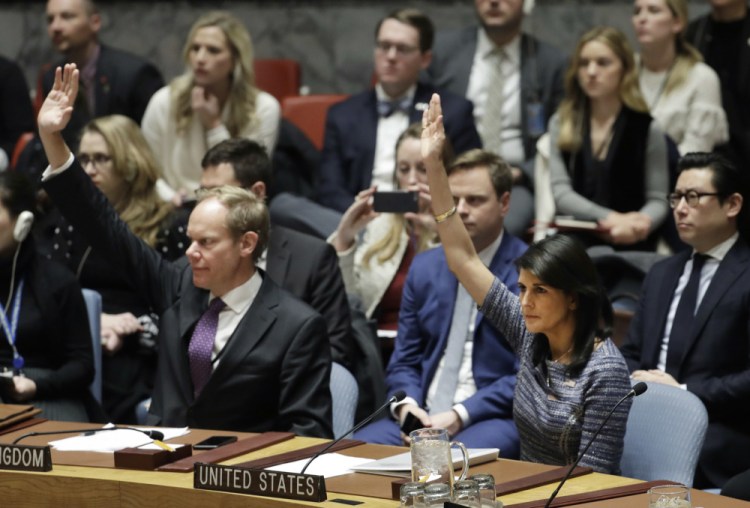 Matthew Rycroft, left, Britain's ambassador to the U.N., and U.S. Ambassador Nikki Haley vote in favor of a resolution Friday at United Nations headquarters. The council was voting on proposed new sanctions against North Korea, including sharply lower limits on its refined oil imports, the return home of all North Koreans working overseas, and a crackdown on the country's shipping.