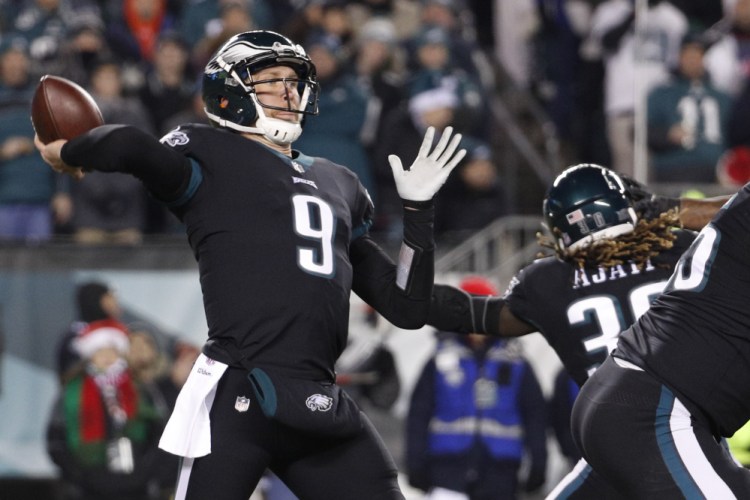Philadelphia quarterback Nick Foles passes against the Oakland Raiders on Monday night in Philadelphia. The Eagles won, to clinch the top seed in the NFC.
