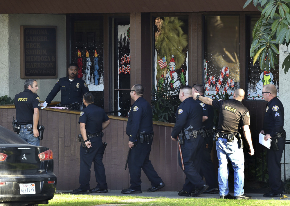 Police gather in front of law offices where a deadly shooting took place in Long Beach, Calif., Friday.