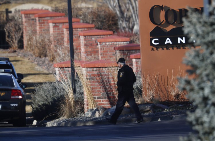 An investigator heads to the scene of a shooting Sunday in Highlands Ranch, Colo. 