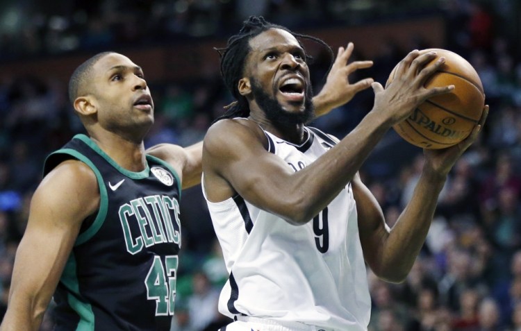 Brooklyn's DeMarre Carroll goes up to shoot in front of Boston's Al Horford during the Celtics' 108-105 win Sunday in Boston.