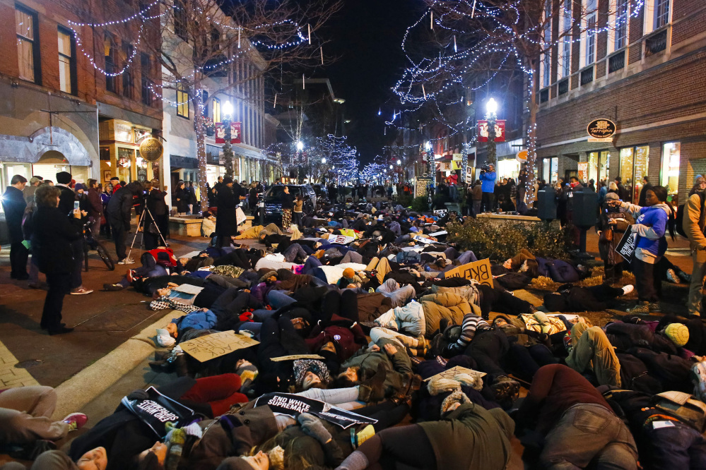 Hundreds of protestors have a die-in during the Kalamazoo Art Walk during a protest in downtown Kalamazoo, Mich. on Friday, Dec. 5, 2014 against the non indictments of the police officers involved in the deaths of Michael Brown in Ferguson, Mo. and Eric Garner in New York City.