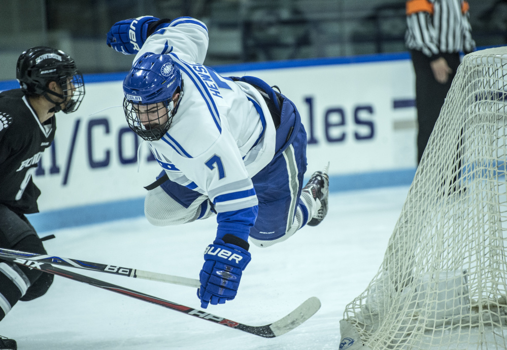WATERVILLE, ME - DECEMBER 1, 2017 
 Colby College's Spencer Hewson (7) flies through the air as he is tripped by Bowdoin College;s Jason Cahoon (9) at Alfond Ice Arena at Colby College in Waterville on Friday, Dec. 1, 2017. (Staff photo by Michael G. Seamans/Staff Photographer)
