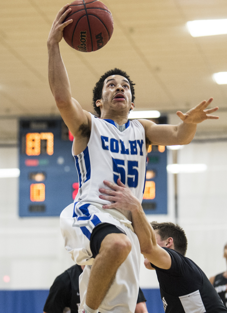 Colby's Wallace Tucker (55) draws the foul from Bowdoin College's Jack Bors (5) on the breakaway Saturday at Colby College in Waterville.