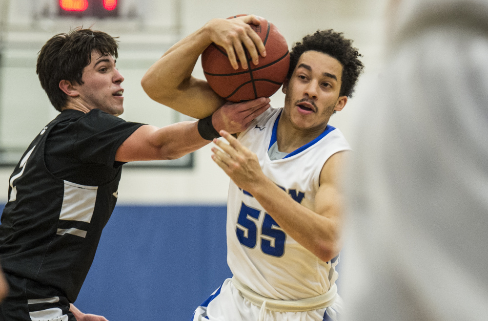 Colby's Wallace Tucker (55) draws the foul from Bowdoin College's Stephen Ferraro (2) on Saturday at Colby College in Waterville.
