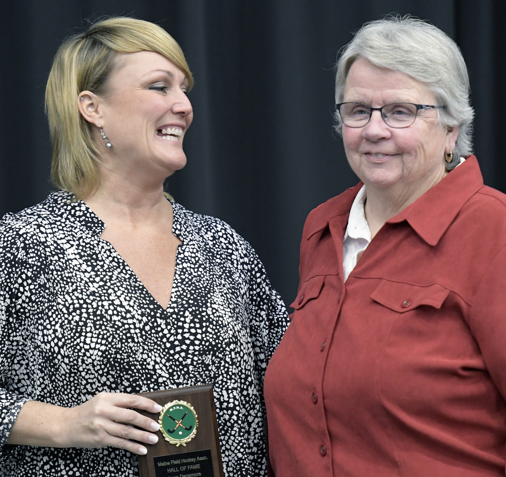 Lesa Densmore, left, poses with Moe McNally, her former Gardiner field hockey coach during the annual Maine Field Hockey Association banquet Sunday at the Augusta Civic Center. Densmore was inducted into the association's Hall of Fame.