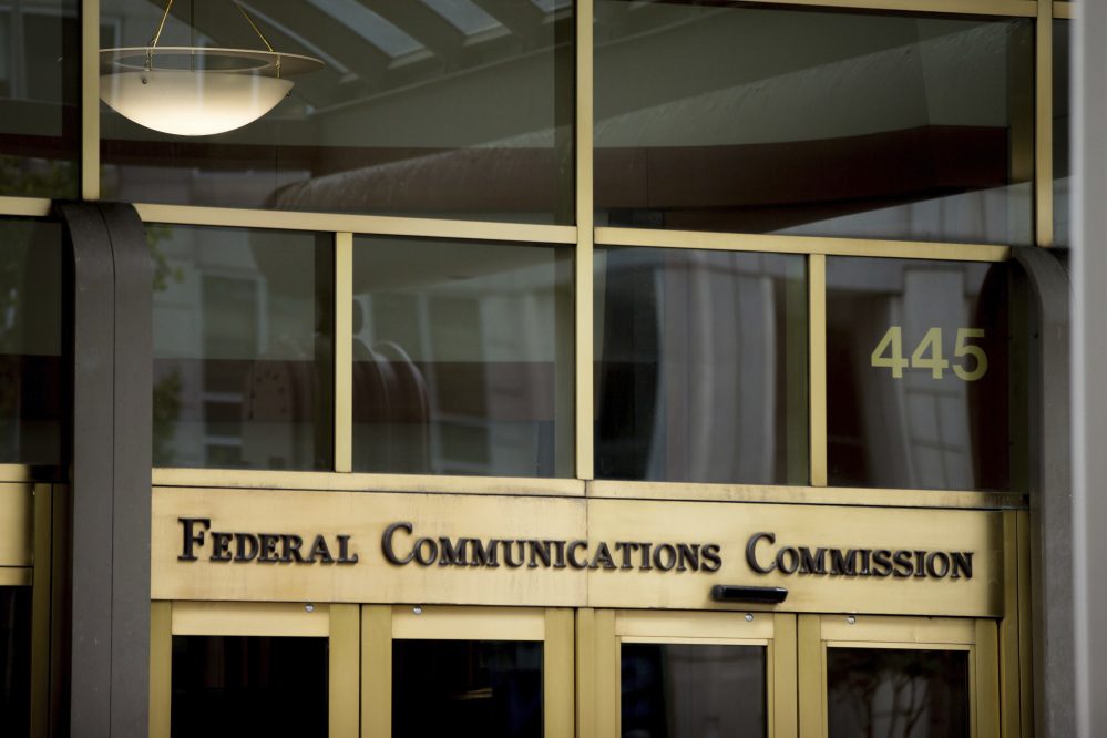 FILE - This June 19, 2015, file photo, shows the Federal Communications Commission building in Washington. Trumpism is slowly taking hold on your phone and computer, as the FCC starts rolling back Obama-era measures, known as "net neutrality" rules, which were designed to keep phone and cable giants from favoring their own internet services and apps. President Donald Trump's hand-picked FCC chief, Ajit Pai, wants to cut regulations that he believes are holding back faster, cheaper internet. (AP Photo/Andrew Harnik, File)
