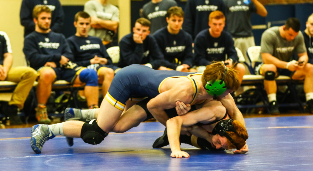 Contributed photo/USM athletics 
 University of Southern Maine sophomore Peter Del Gallo, top, pins down Shawn Ferrell of Bridgewater State during a 125-pound match at the Costello Sports Complex in Gorham. Del Gallo pinned Ferrell in 48 seconds.