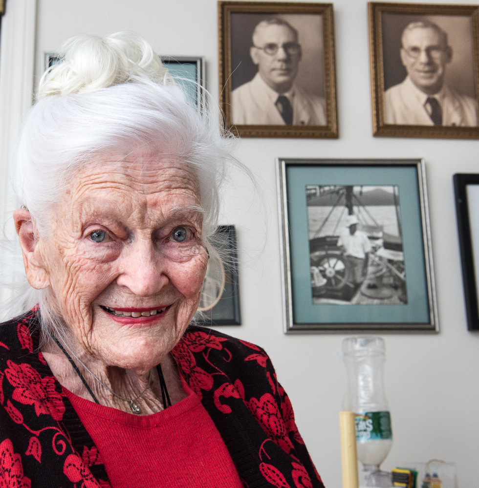 Hope Weston relaxes in her apartment Wednesday at Schooner Estates in Auburn. Behind her are photographs of her father when they lived in the Philippines before World War II, when the country was a U.S. possession.
