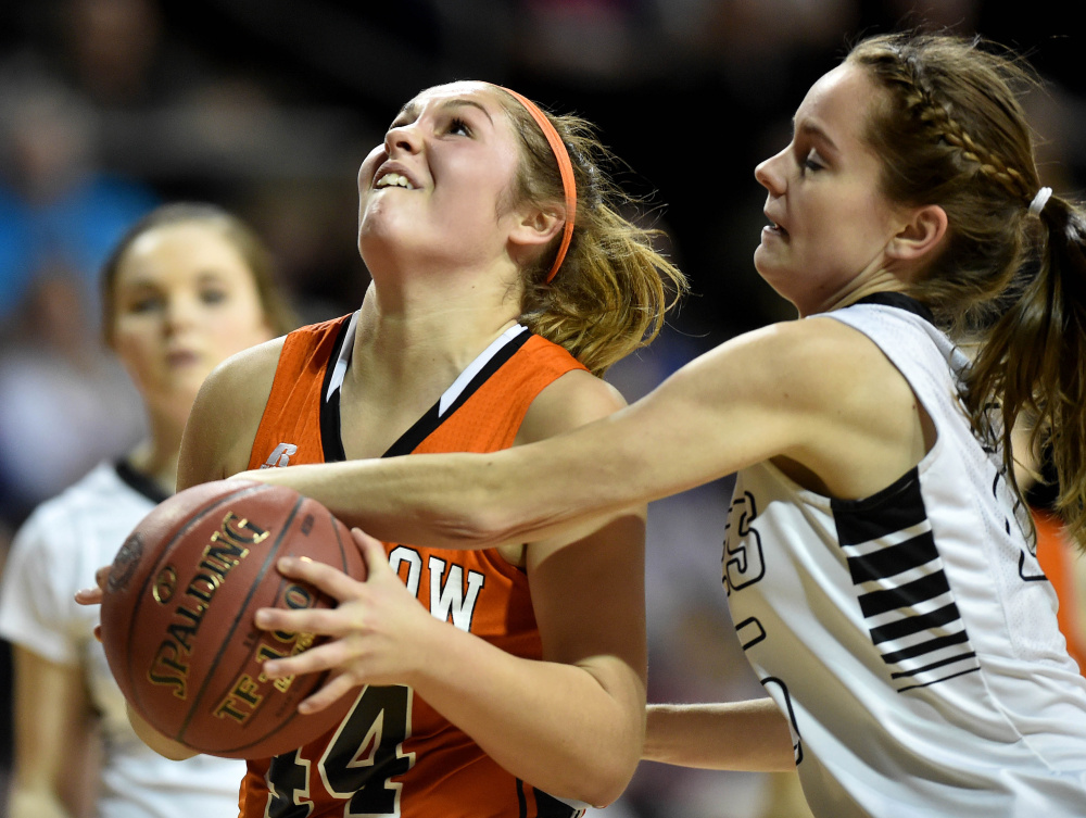Keep away: Winslow guard Weslee Littlefield, left, draws a foul from Houlton's Megan Collett during a Class B North semifinal last season at the Cross Insurance Center in Bangor.