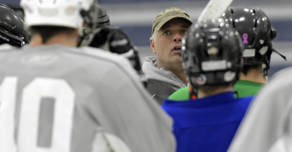Gardiner hockey coach Sam Moore talks to his team during a Nov. 28 practice in Hallowell.