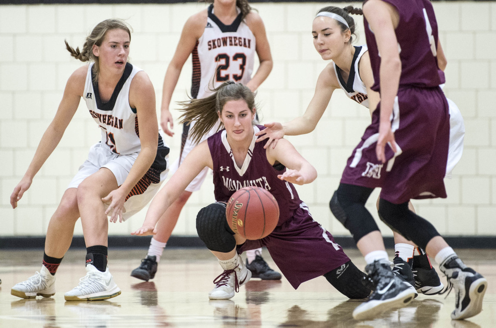 Skowhegan forward Annie Cook, left, and teammate Emma Duffy, right, battle for a loose ball with Monmouth's Kaeti Butterfield during an exhibition game this preseason.