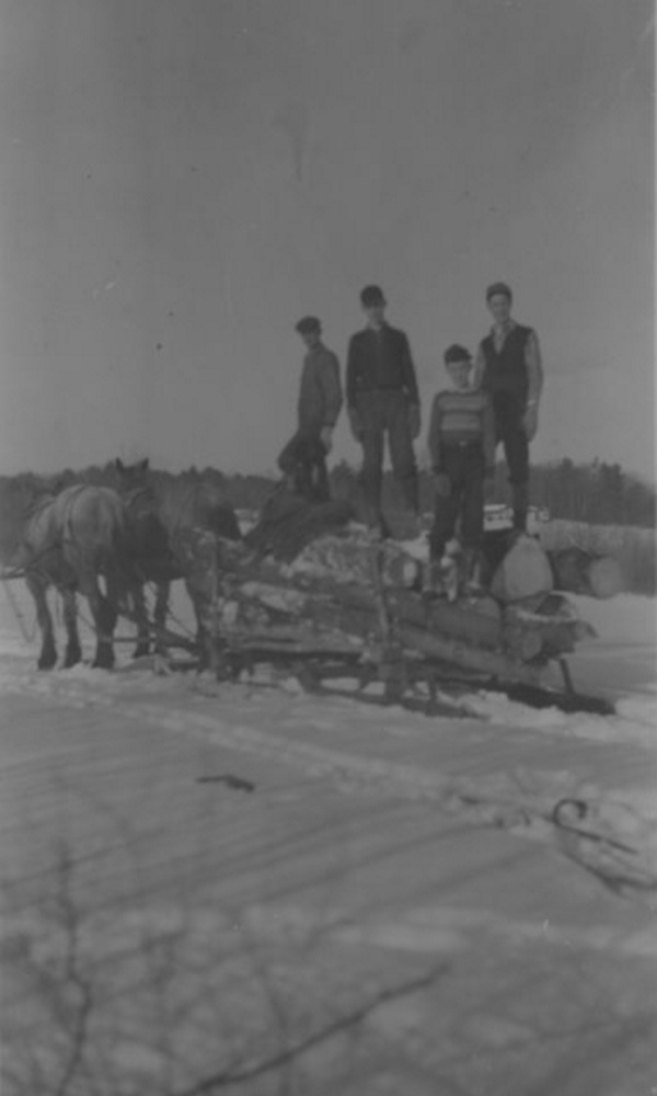 The January photo in the Jefferson Historical Society's 2018 calendar, Orla Johnson, left, and his sons Leon, Erland and Richard, in front, bring out a load of logs taken from their property on Bunker Hill Road. The Johnstons logged, hauled and cut wood to burn in their home or to sell in the 1940s.