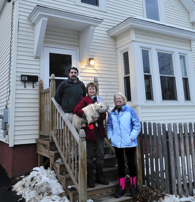 Waterville Community Land Trust members Scott McAdoo, Nancy Williams and Ann Beverage at a home the organization bought and is selling at 181 Water St. in Waterville on Monday.