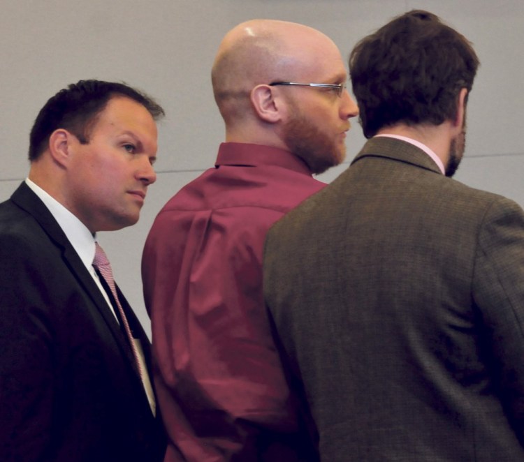Robert Burton, center, with his attorneys, Zachary Brandmeir, left, and Hunter Tzovarras, at Penobscot Judicial Center in Bangor, listens to his guilty verdicts being read.