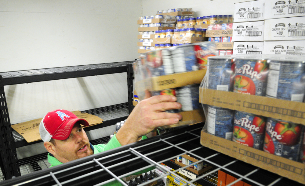 Warehouse manager Andy Waller stocks shelves Tuesday in the new Augusta Food Bank in Augusta.