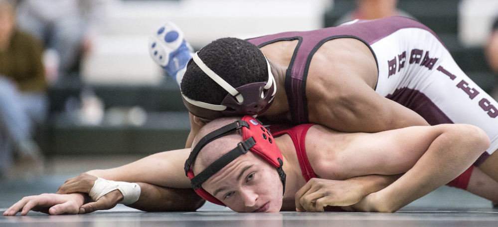 Maine Central Institute senior ZyAnthony Moss gets Dexter's Isaac Webber down to the mat in a 132-pound match last Saturday at Mount View High School in Thorndike.