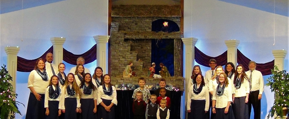 Teen/adult choir members and junior choir members on the set of "Christmas on the Air" to be presented at the New Hope Baptist Church, 268 Perham St. The adult choir group on the left, in front from left are Giulia Johnson, Georgia Cavenaugh, Haven Doyle and Erin Johnson; middle row, from left are JoAnne Doyle, Lydia Doyle, Kamrin Yates and Jessie Johnson; in back, from left are Kirk Doyle and Tom Charles. The childrens' choir in the center are, in front, from left, Elijah and Josiah Phillips; second row, from left are Micah Phillips and Autumn Decker; in back, from left are Evan Pinkham and Dalton Yates. The group on the right are, in front, from left, Sandi Rebert and Heather Wheeler; second row, from left are Madison Yates, Hannah Winters and Janna Winslow; in back, from left, are John and Valerie Trabucchi and Brian Rebert.