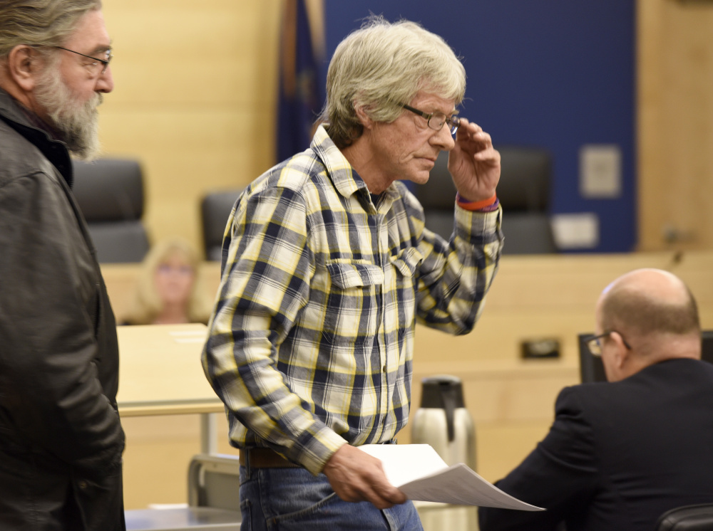 Vance Ginn, right, returns to his seat after testifying about his daughter, Stephanie Gebo, at Penobscot Judicial Center on Friday during the sentencing of Robert Burton for the murder of Gebo. Ginn later spoke of the need to use ankle monitoring bracelets to prevent assaults and murders by domestic violence perpetrators like Burton.