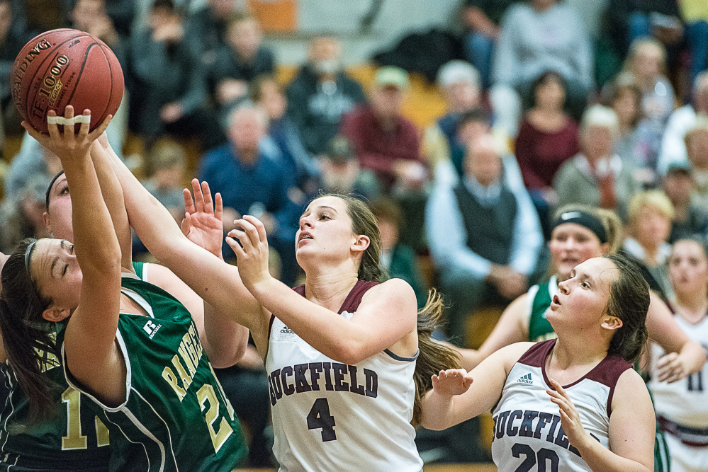 Rangeley's Winnie Larochelle and Buckfield's Caroline Trimm fight for a rebound during a Class D South game Friday night in Buckfield